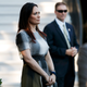 In this June 21, 2019 photo, Stephanie Grisham, spokeswoman for first lady Melania Trump, watches as President Donald Trump and the first lady greet attendees during the annual Congressional Picnic on the South Lawn in Washington.
